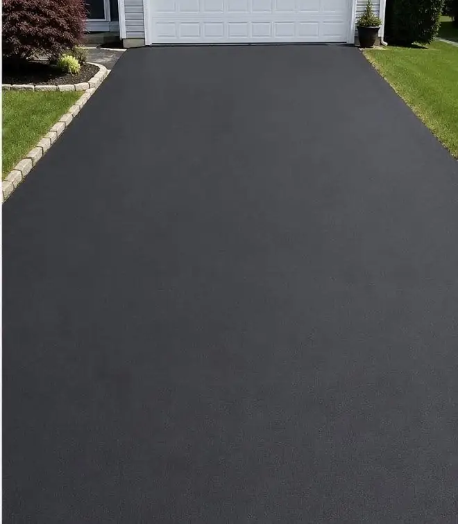 The same driveway after sealcoating, a deep even black with clean edges
